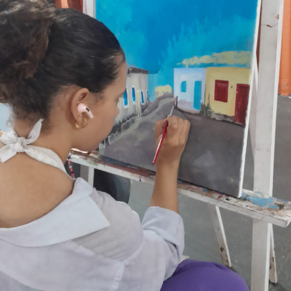 Aluna de curso de Artes Visuais do Basileu França pintando tela