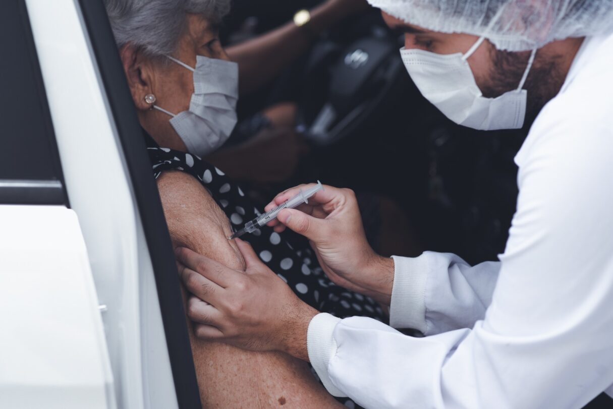 Pessoa idosa recebendo vacina bivalente contra covid-19