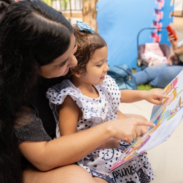 MÃE E FILHO LENDO LIVRO NO projeto literário do Meninas de Luz